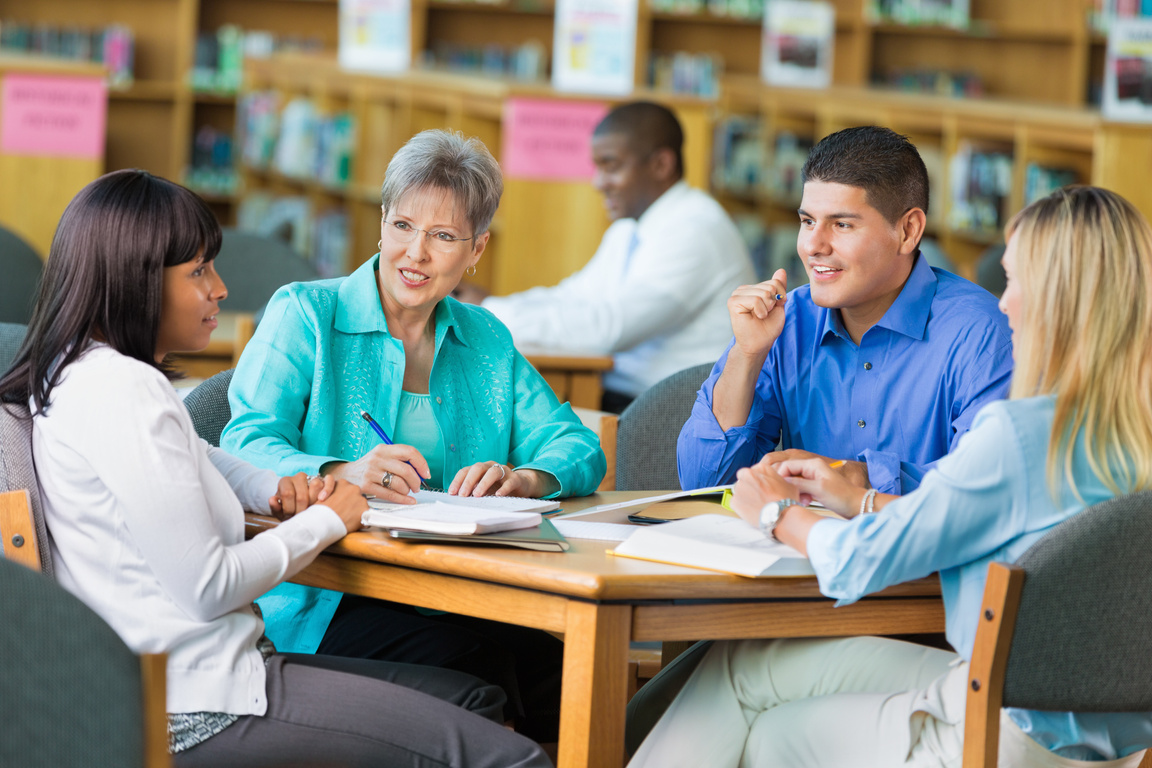 Group of teachers meet in library