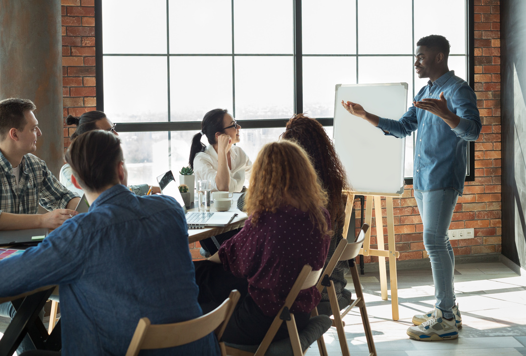 African-american leader lecturing his employees in office